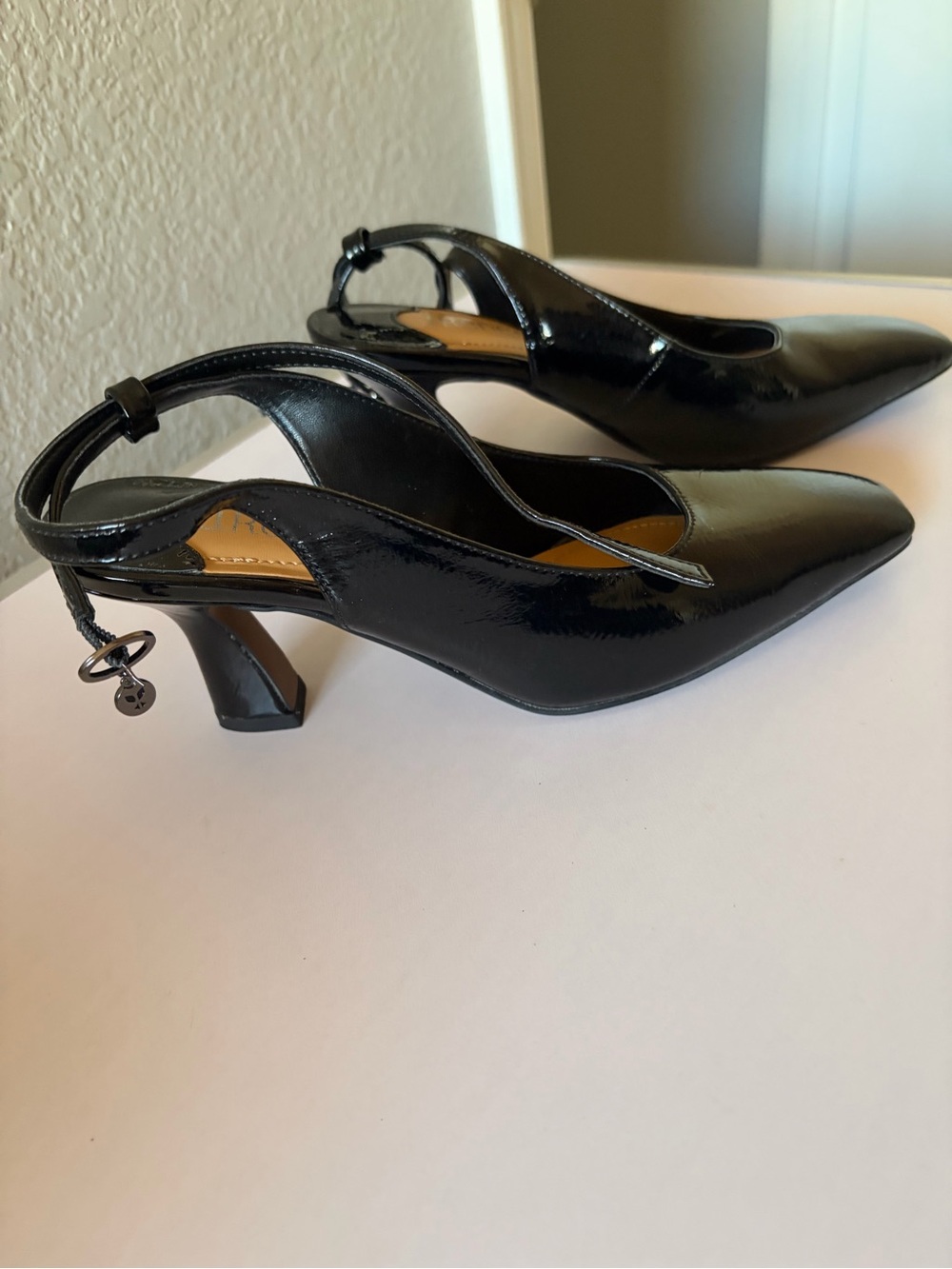 Patent Black Slingback Pointed-Toe Heels with Charm Accent
